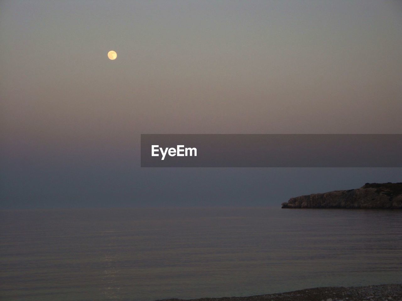 Scenic view of sea against sky at dusk