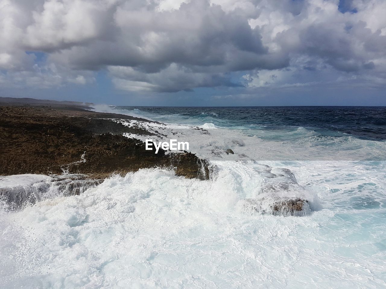 Scenic view of sea against storm clouds