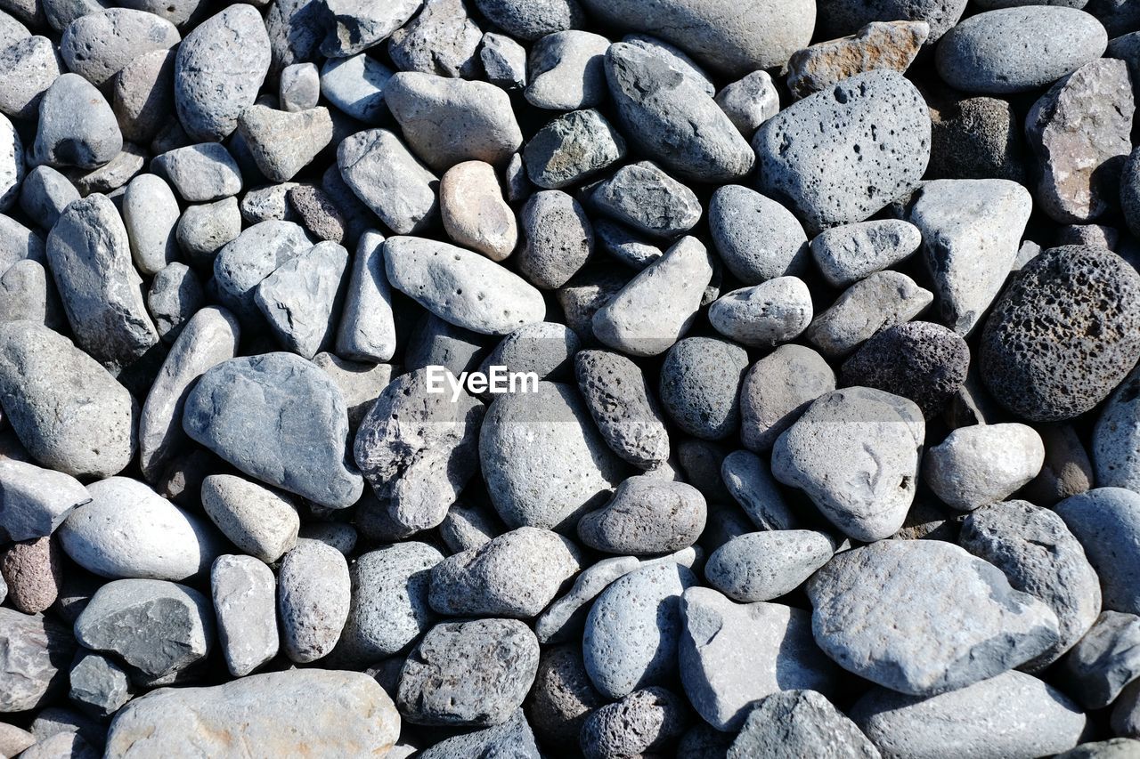 Full frame shot of stones on sunny day