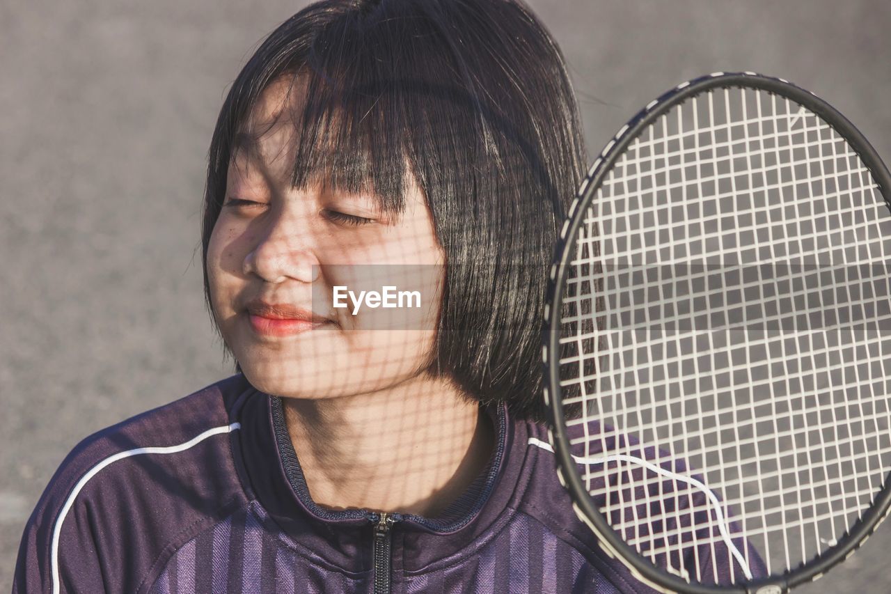 New normal lifestyle, free from disease. portrait of young woman with badminton racket.