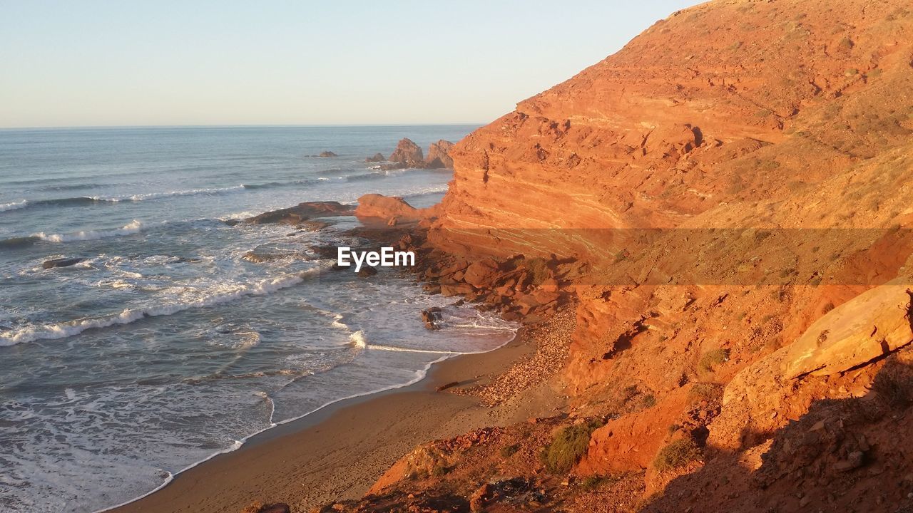 Scenic view of beach against clear sky