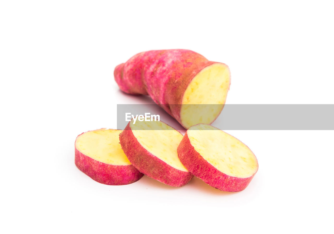 Close-up of sliced sweet potato against white background