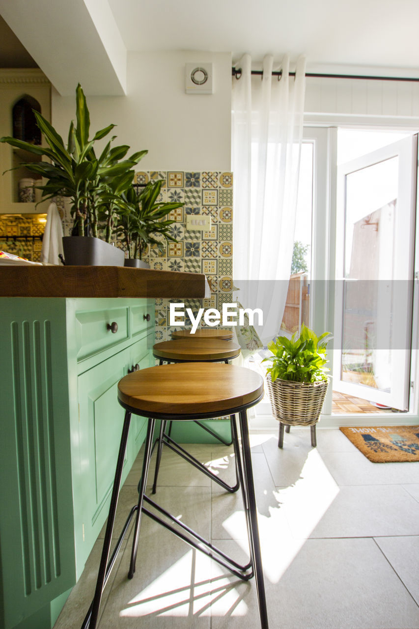 Stools at breakfast bar at home