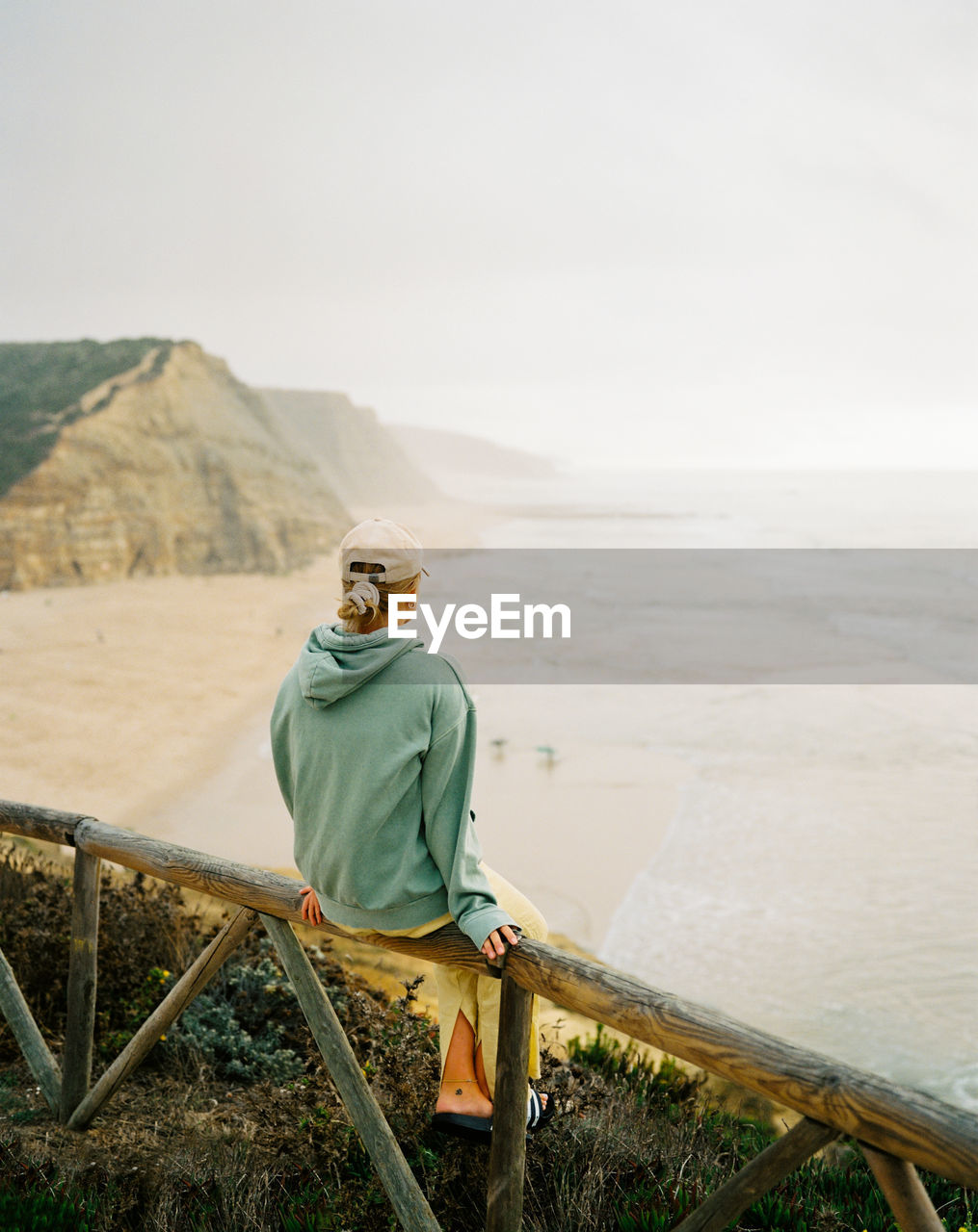 Rear view of woman watching the ocean