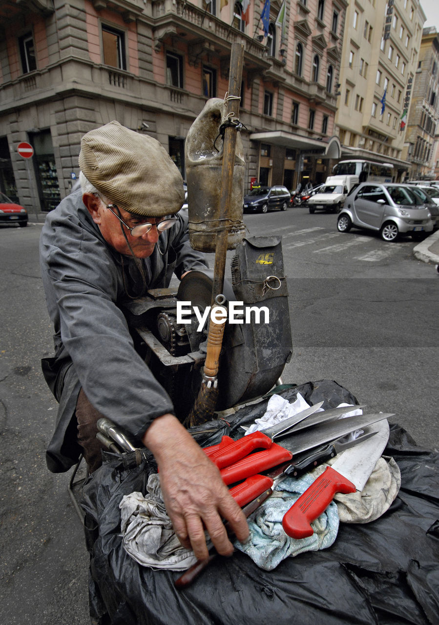 High angle view of knife grinder on street in city