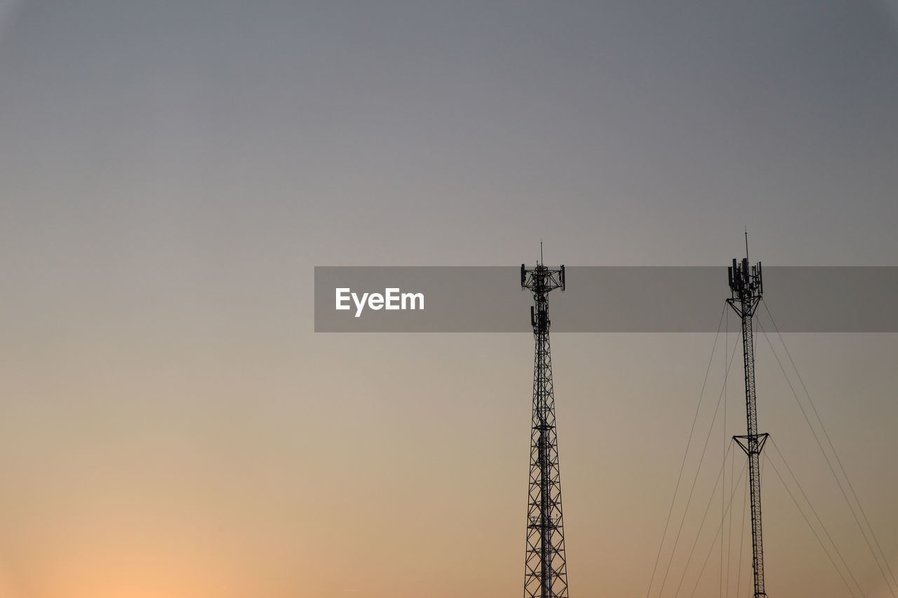 Colorful cloud with communication signal tower silhouette.