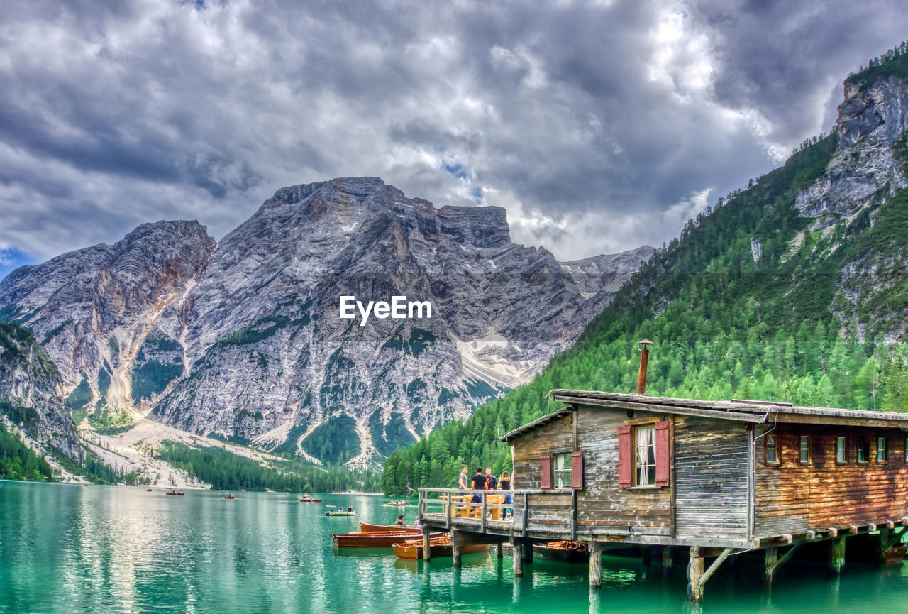 Scenic view of lake and mountains against sky in italy- braies 