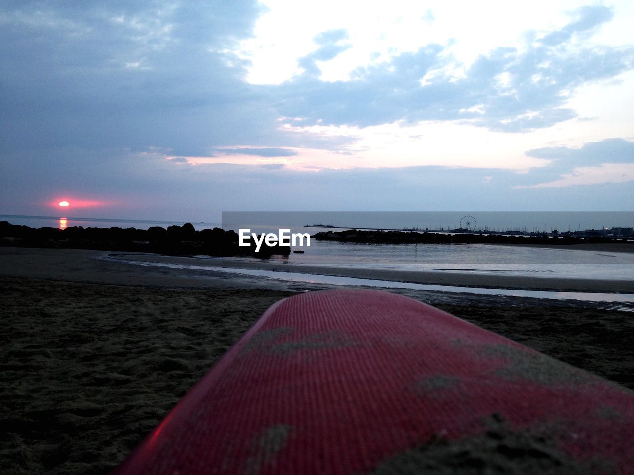 SURFACE LEVEL OF BEACH AGAINST SKY