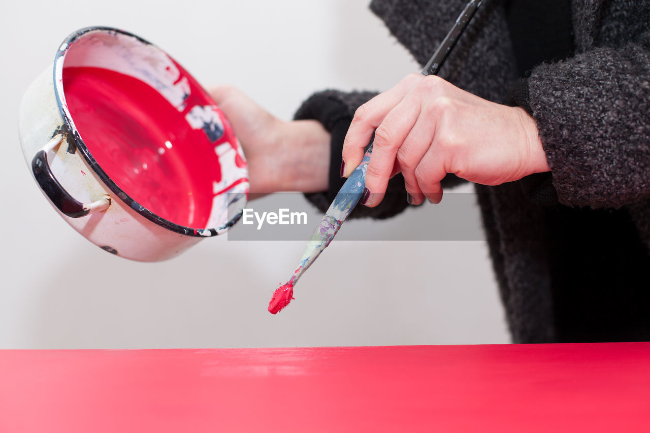 Close up of woman holding paintbrush