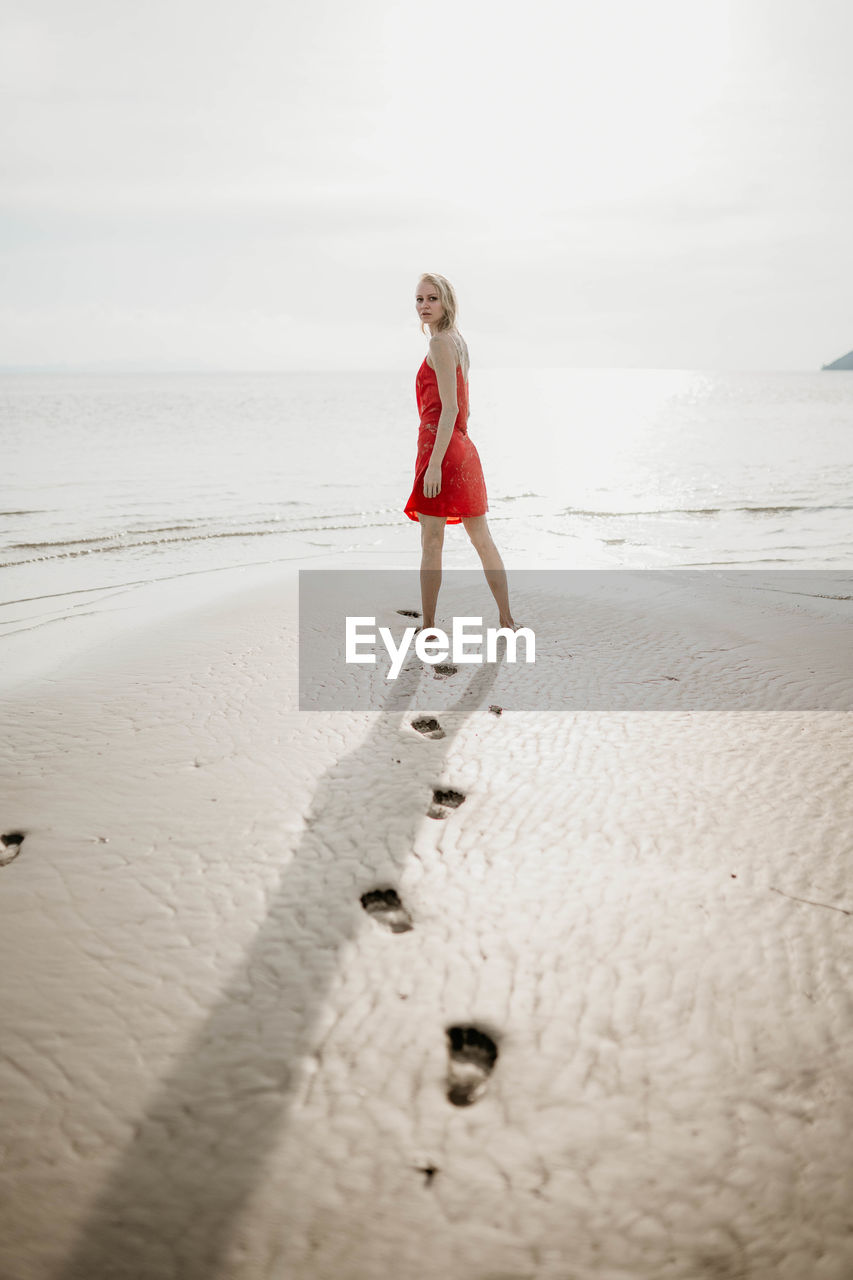 Full length of woman walking at beach