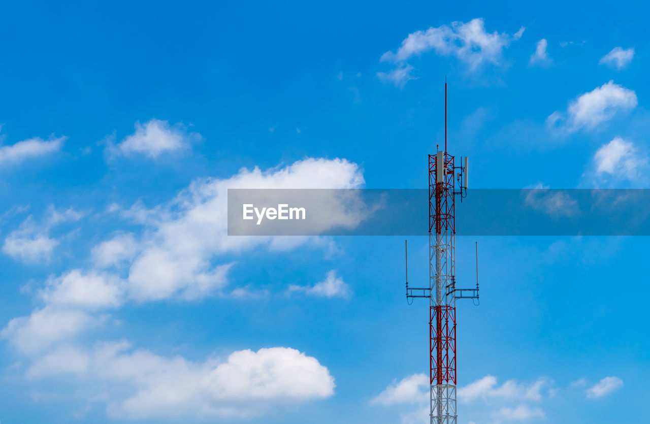 Telecommunication tower with blue sky and white clouds background. antenna on blue sky. 