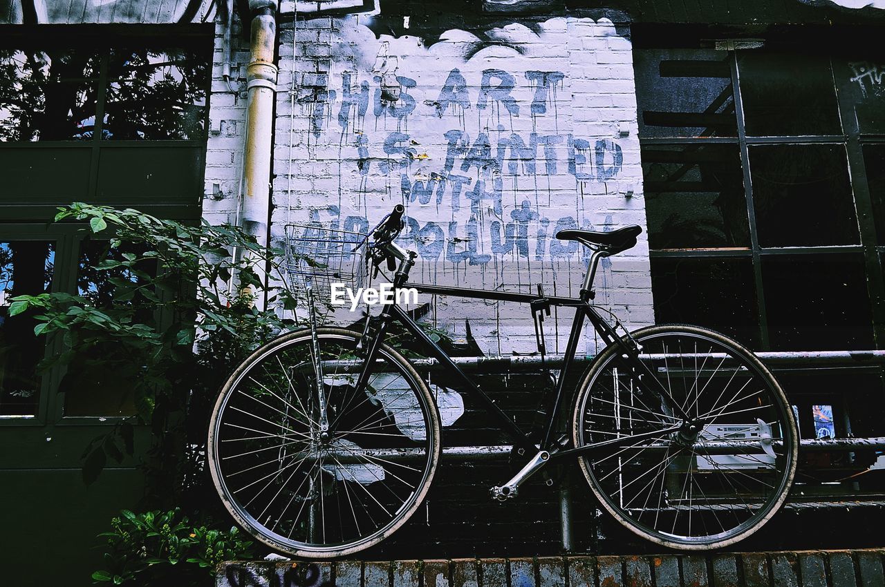 BICYCLE AGAINST BUILDING