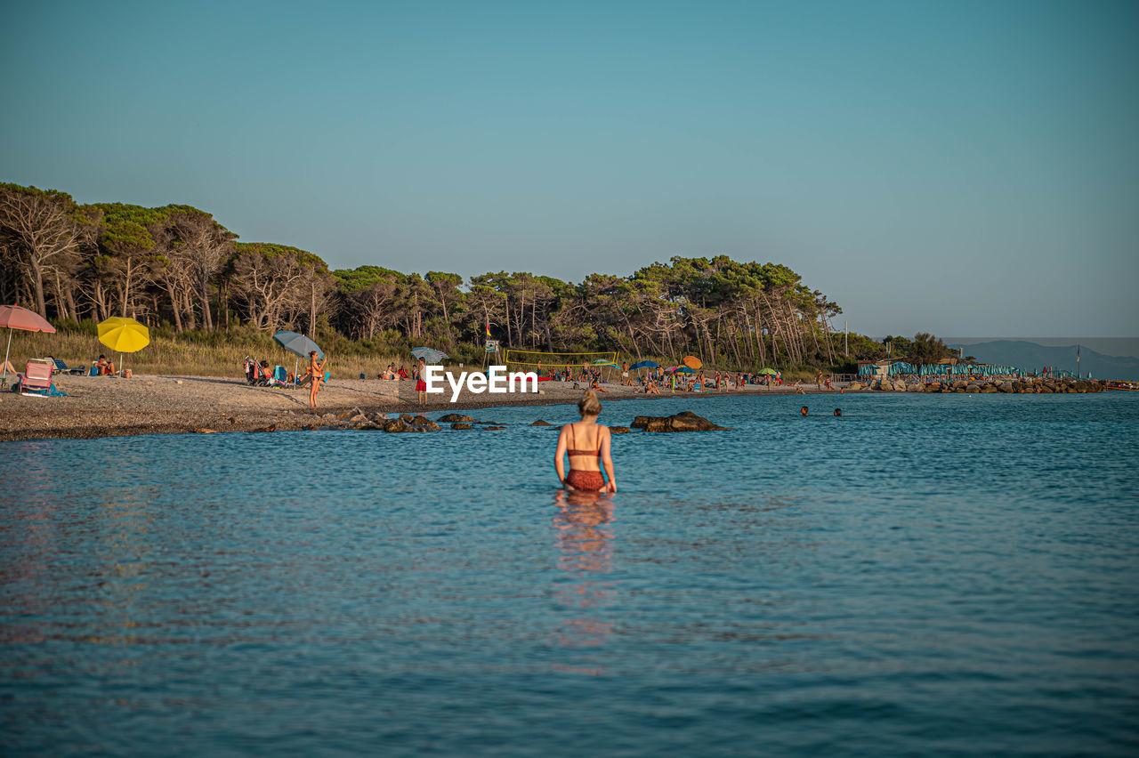 Young woman at italian beach while sunset