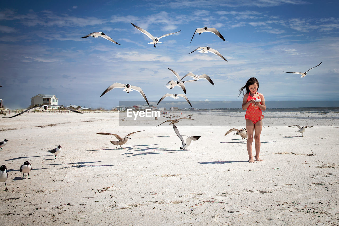 Full length of girl standing on beach