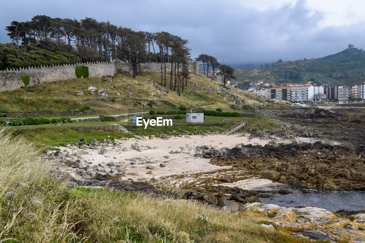 View of the beach of os frades in baiona - spain. small beach located next to the fortress 