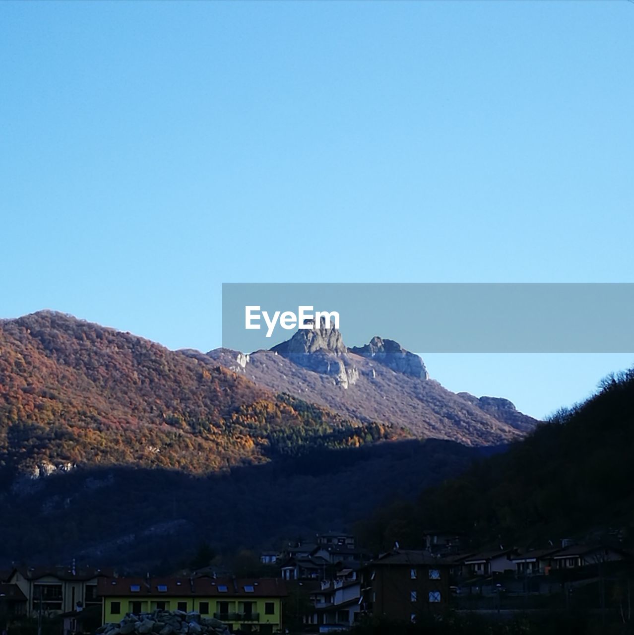 SCENIC VIEW OF MOUNTAINS AGAINST BLUE SKY