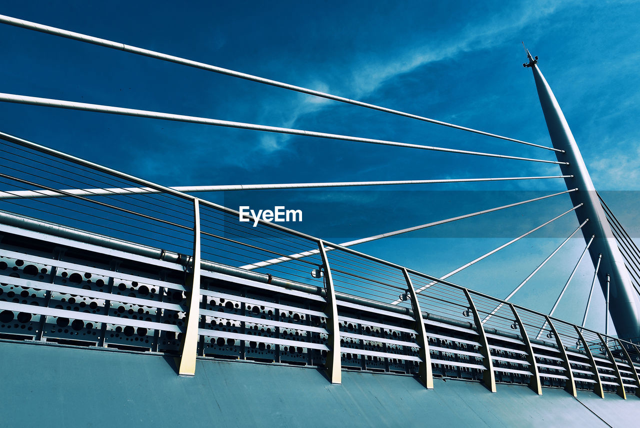 Low angle view of bridge against blue sky