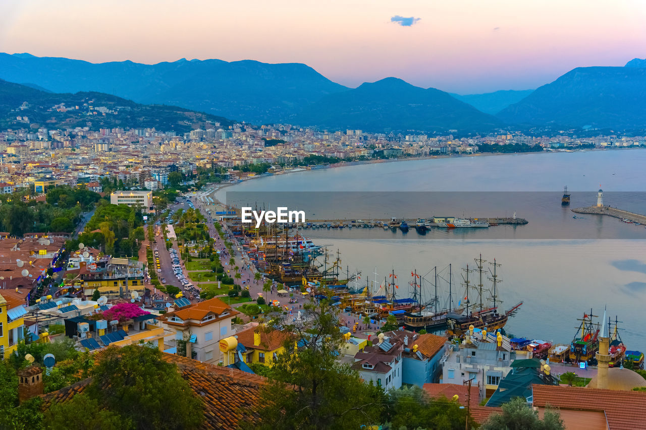 Scenic view of sea by city against sky