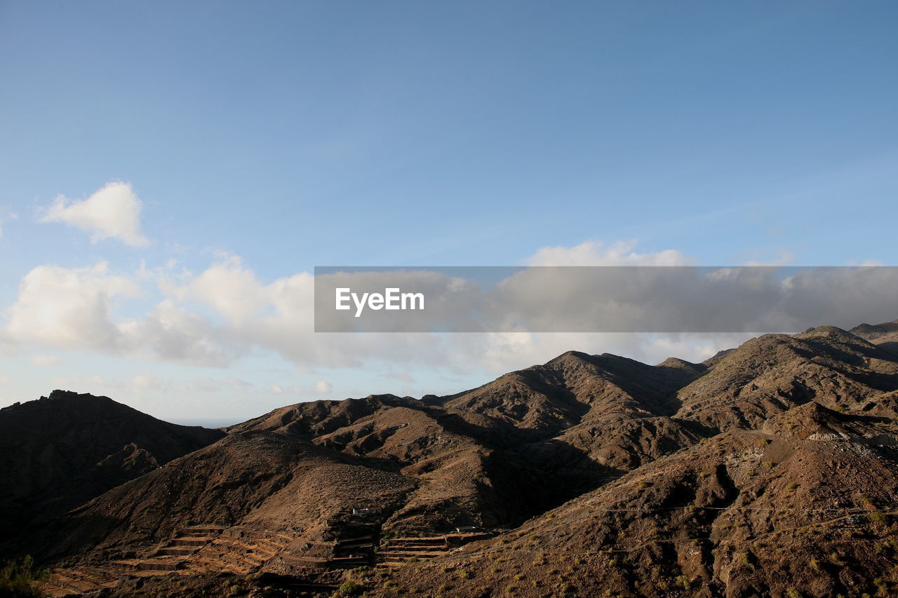 Scenic view of volcanic hills  against sky