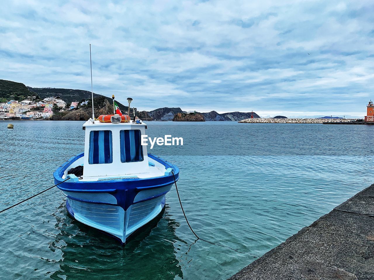 Ship moored on sea against sky