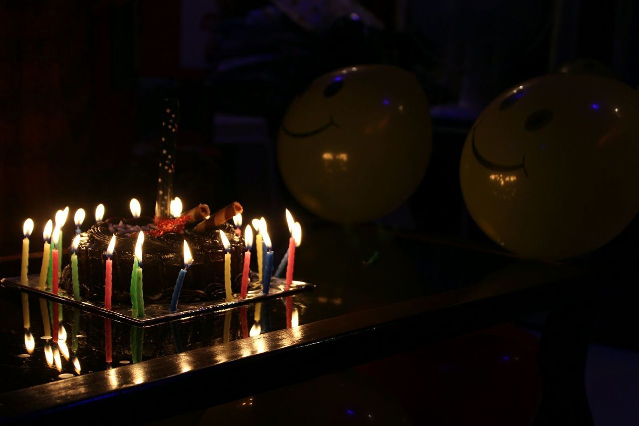 CLOSE-UP OF ILLUMINATED CANDLES