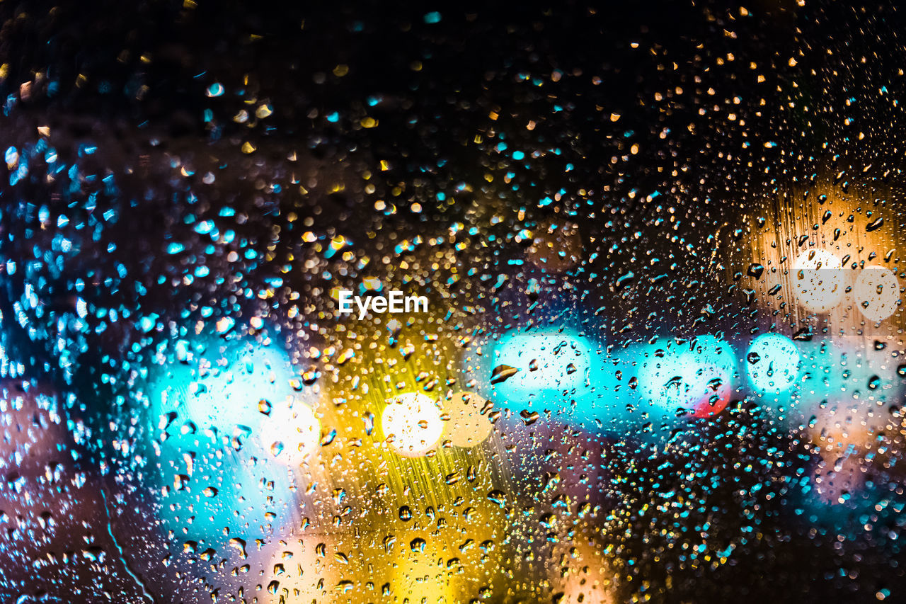 Full frame shot of wet car window at night