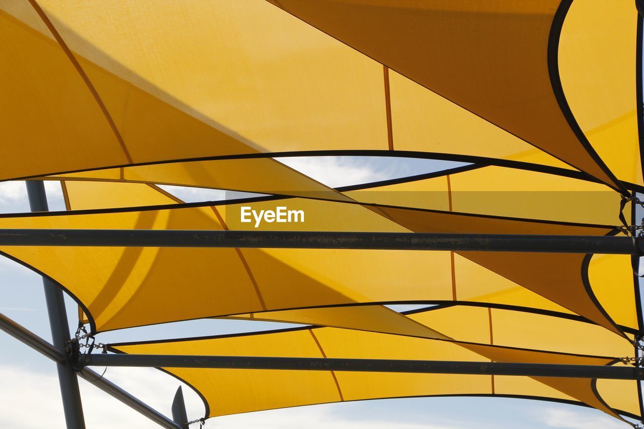 LOW ANGLE VIEW OF YELLOW STRUCTURE