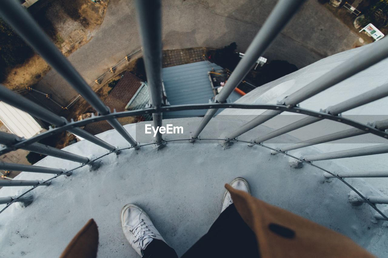Low section of person standing on staircase