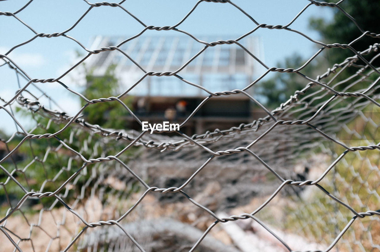 Full frame shot of chain link fence to a home