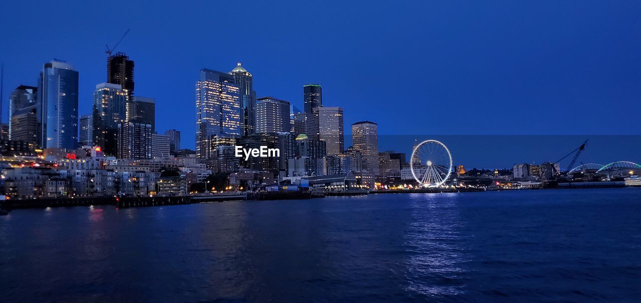 Seattle ferris wheel from the water at night