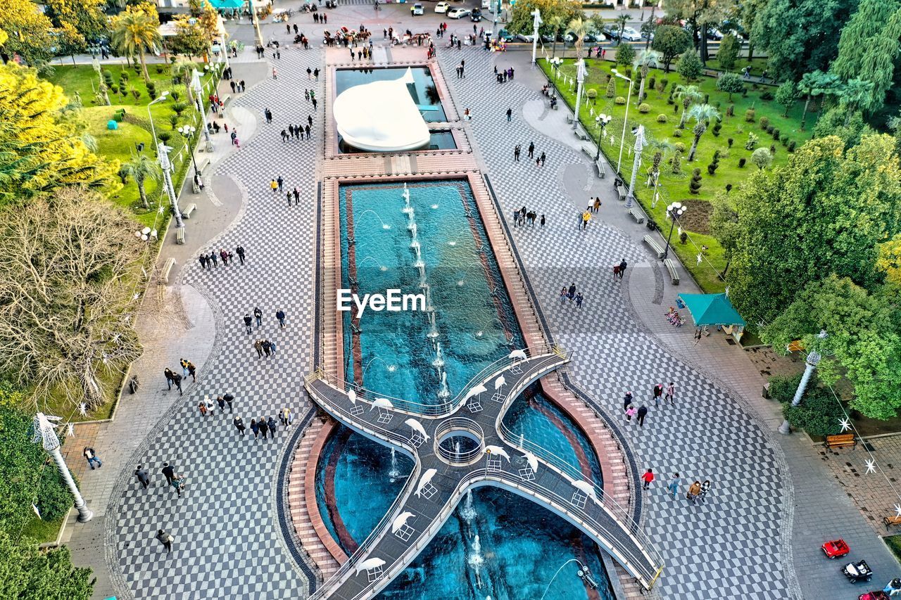 HIGH ANGLE VIEW OF SWIMMING POOL BY CITY