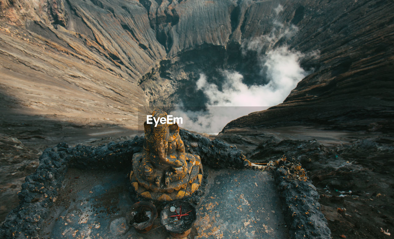 Close-up of ganesha statue against volcanic crater
