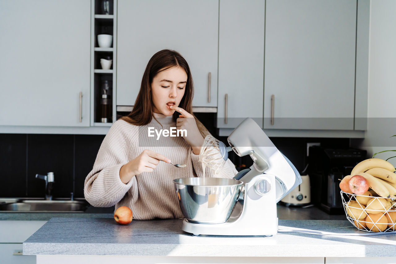 Cute girl preparing food at home