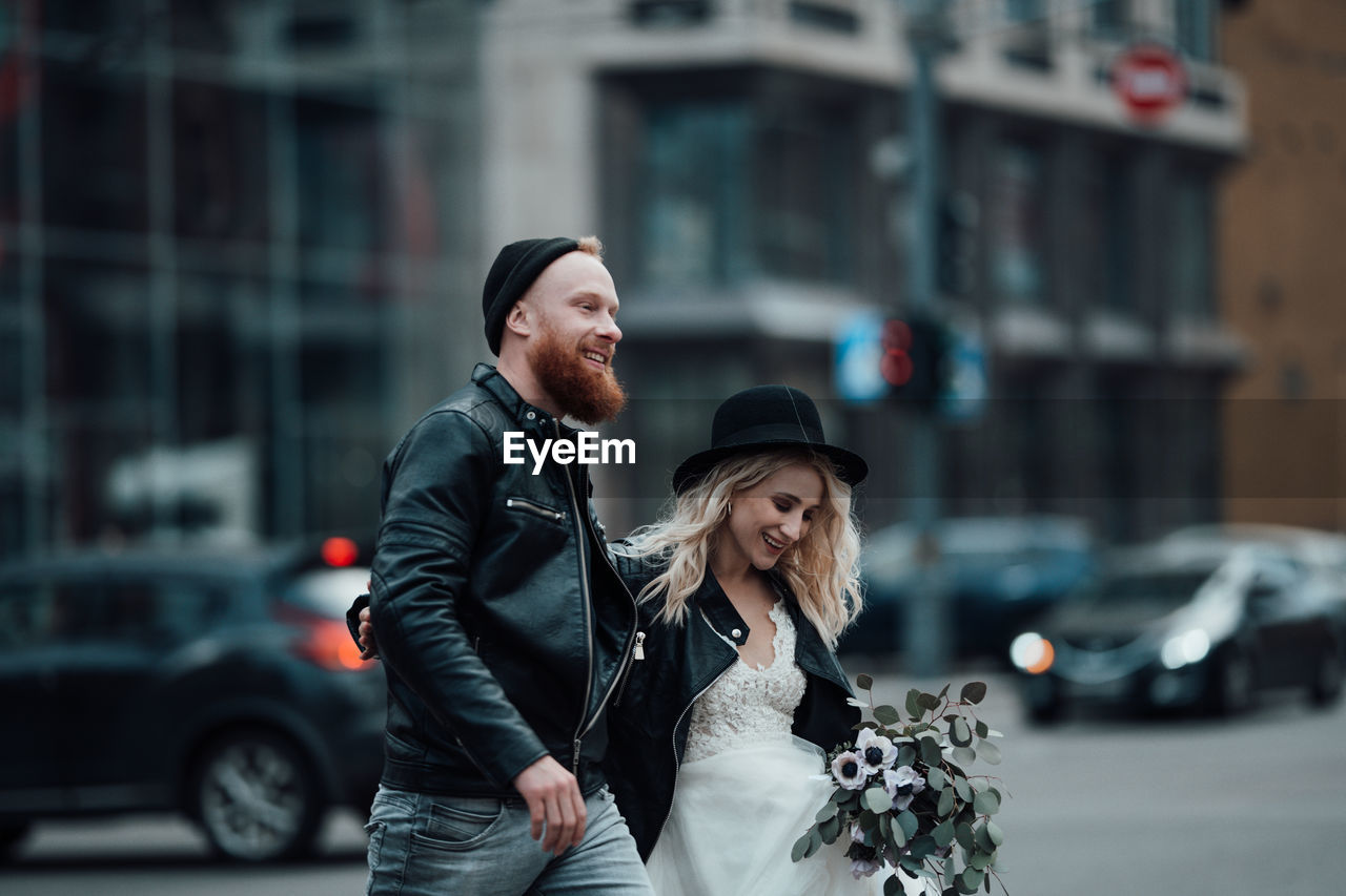 Young couple standing on street in city