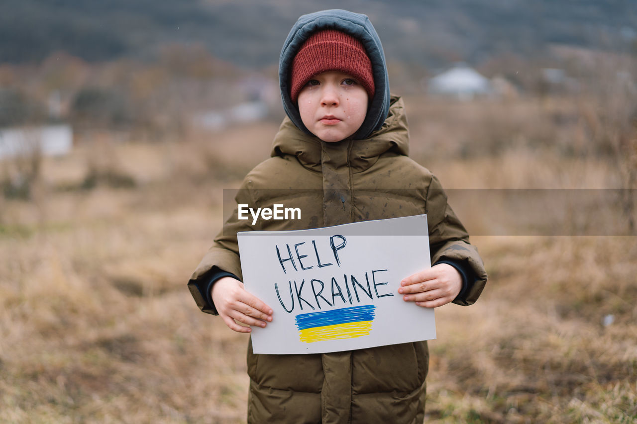 War of russia against ukraine. crying boy asks to stop the war in ukraine.