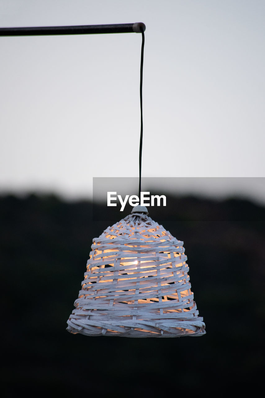 CLOSE-UP OF METAL HANGING AGAINST SKY