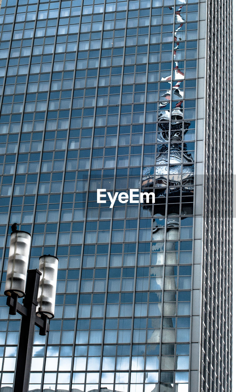 Reflection of fernsehturm tower on glass building