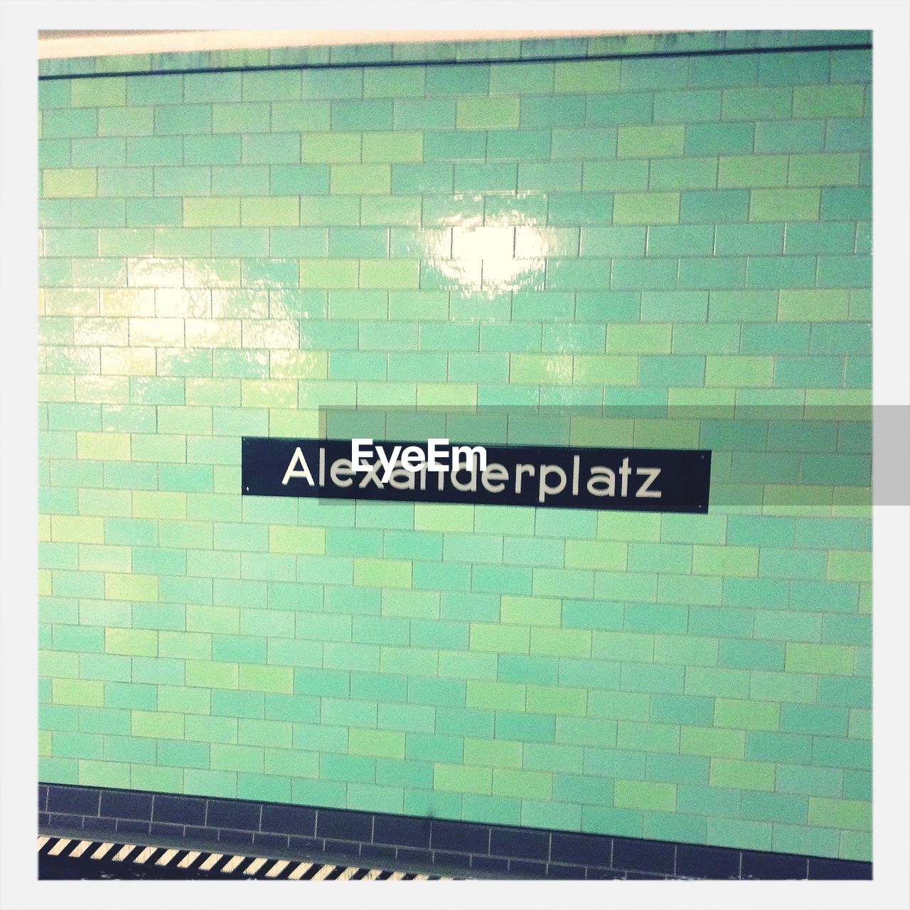 Alexanderplatz written on wall of underground subway