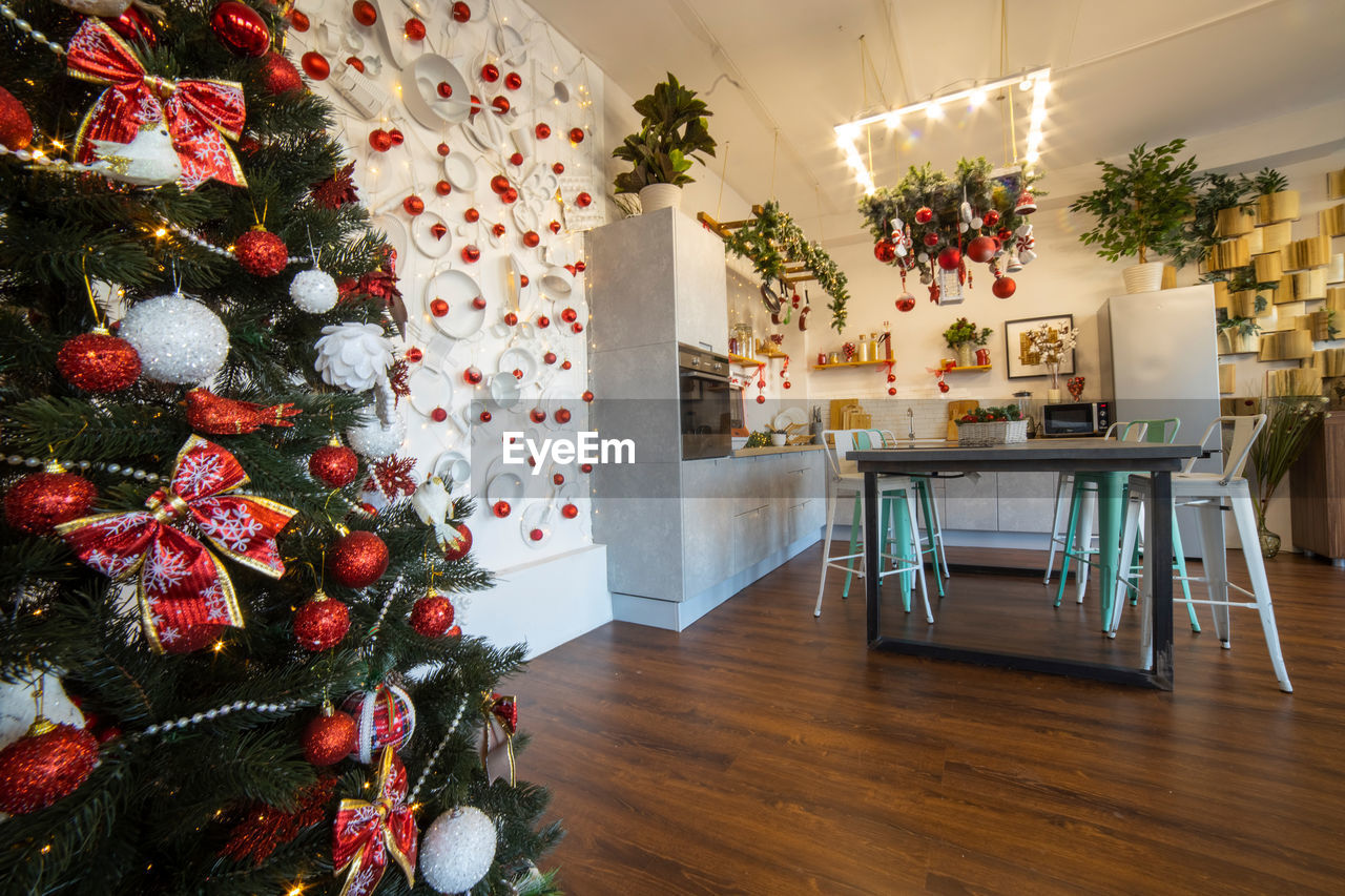 Interior of a cozy modern spacious kitchen for a large family, decorated for  new year celebration