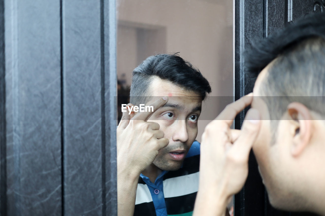 PORTRAIT OF MAN WITH REFLECTION