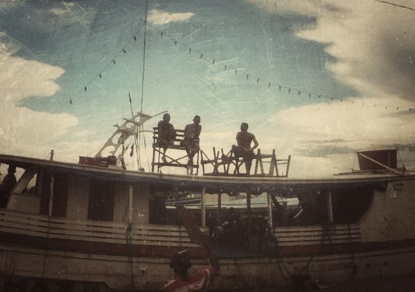 PEOPLE STANDING ON RAILING