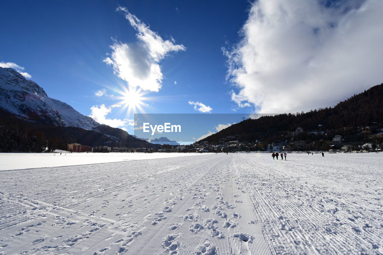 Scenic view of snow covered field against sky