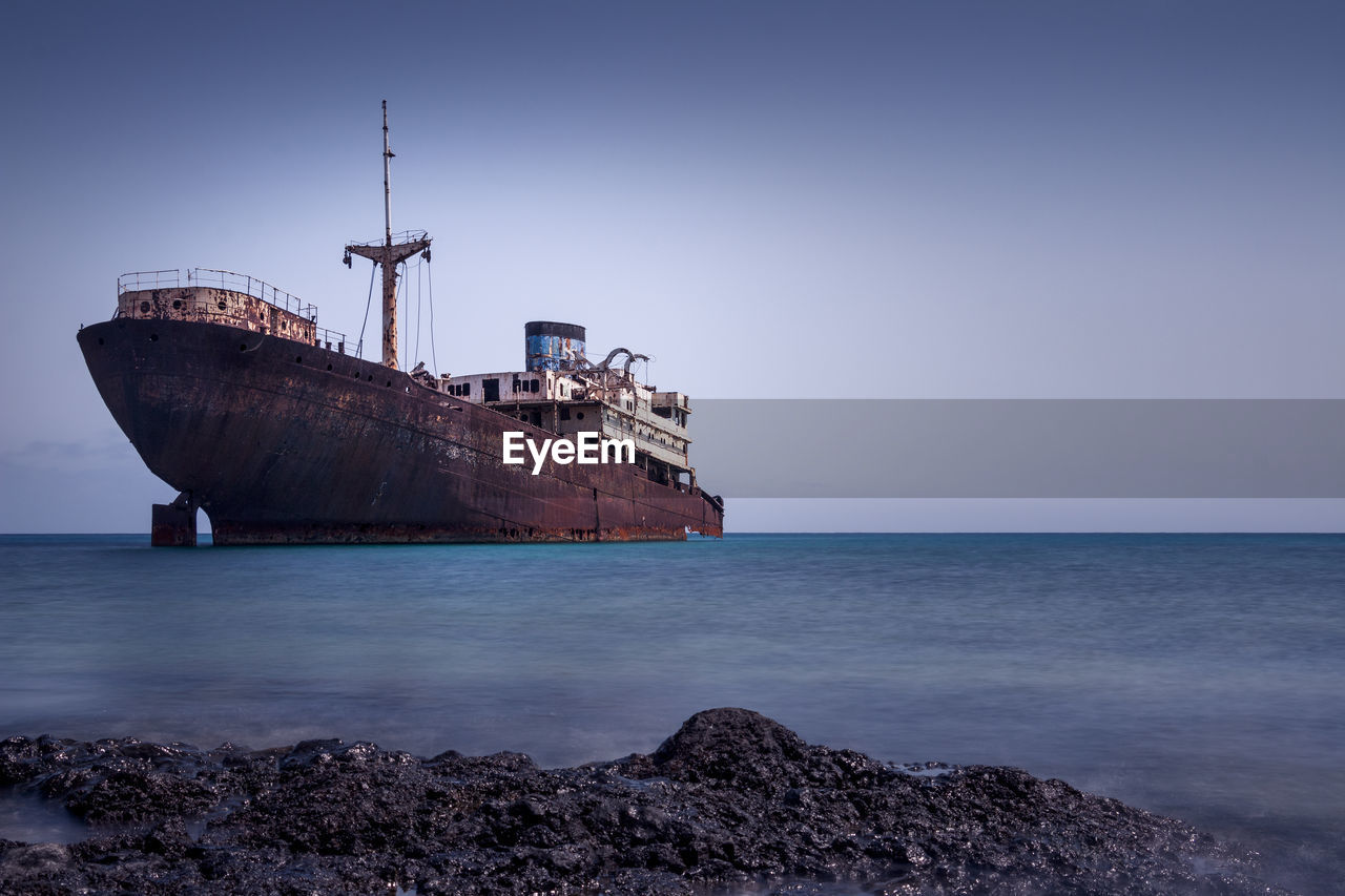 Scenic view of ship against sky