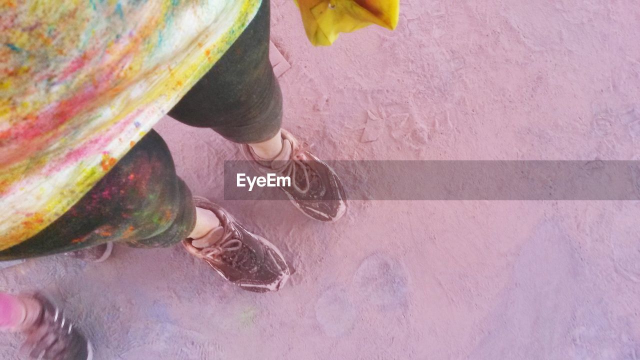 Low section of woman standing on messy field