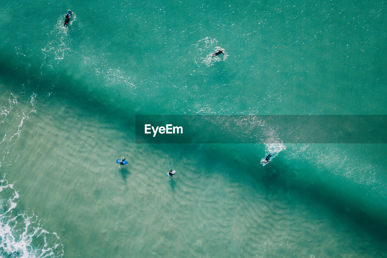High angle view of people surfing in sea