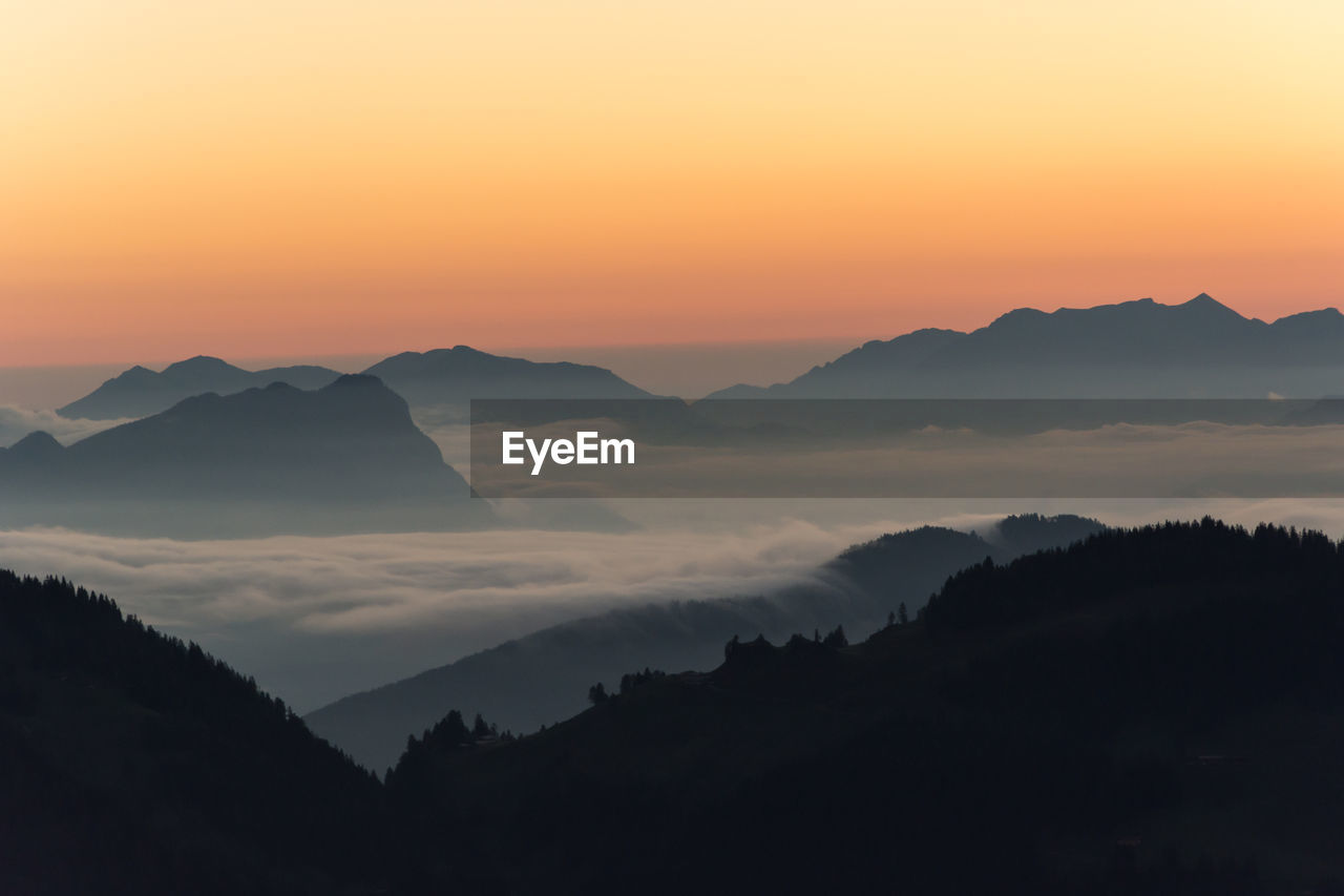 SCENIC VIEW OF MOUNTAINS AGAINST SKY DURING SUNSET