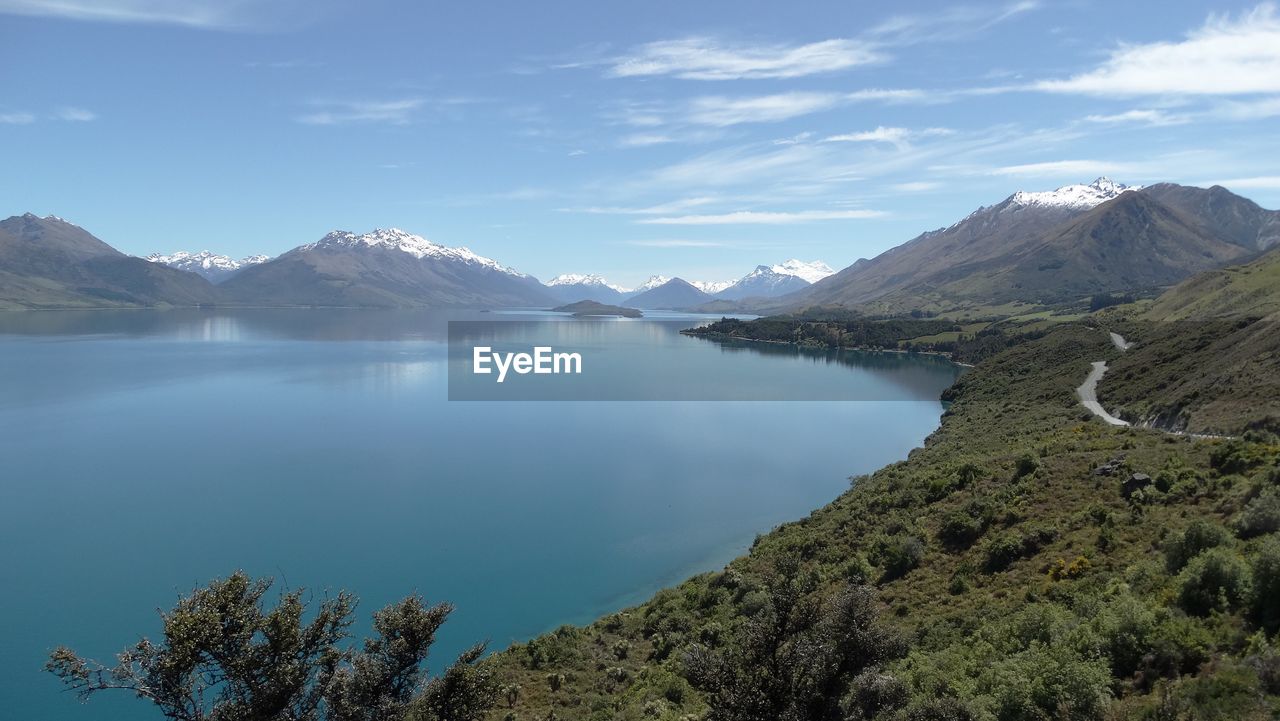 Scenic view of lake and mountains against sky