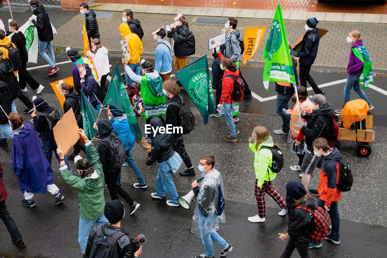 HIGH ANGLE VIEW OF PEOPLE WALKING ON STREET