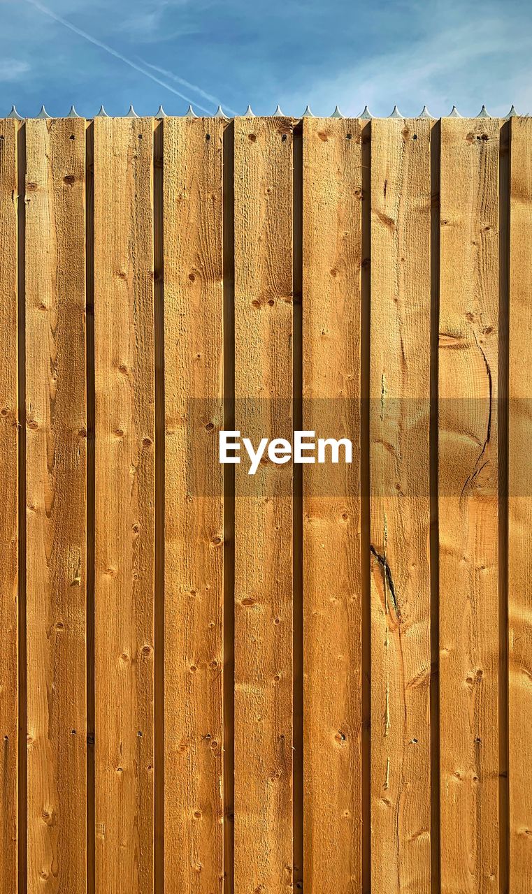 Close-up of wooden fence against sky