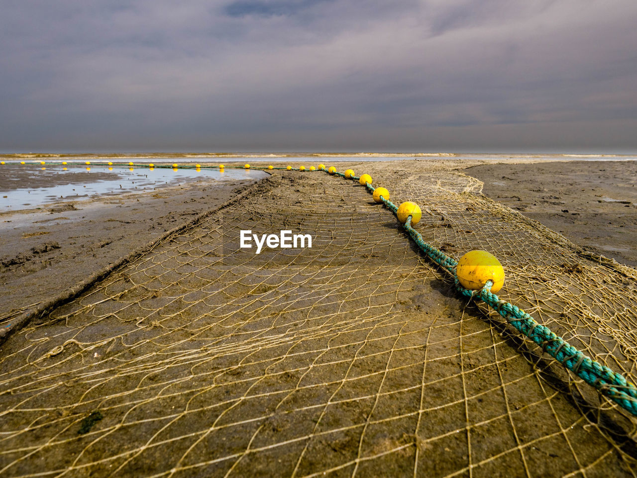 Fishnet layed out at the beach drying